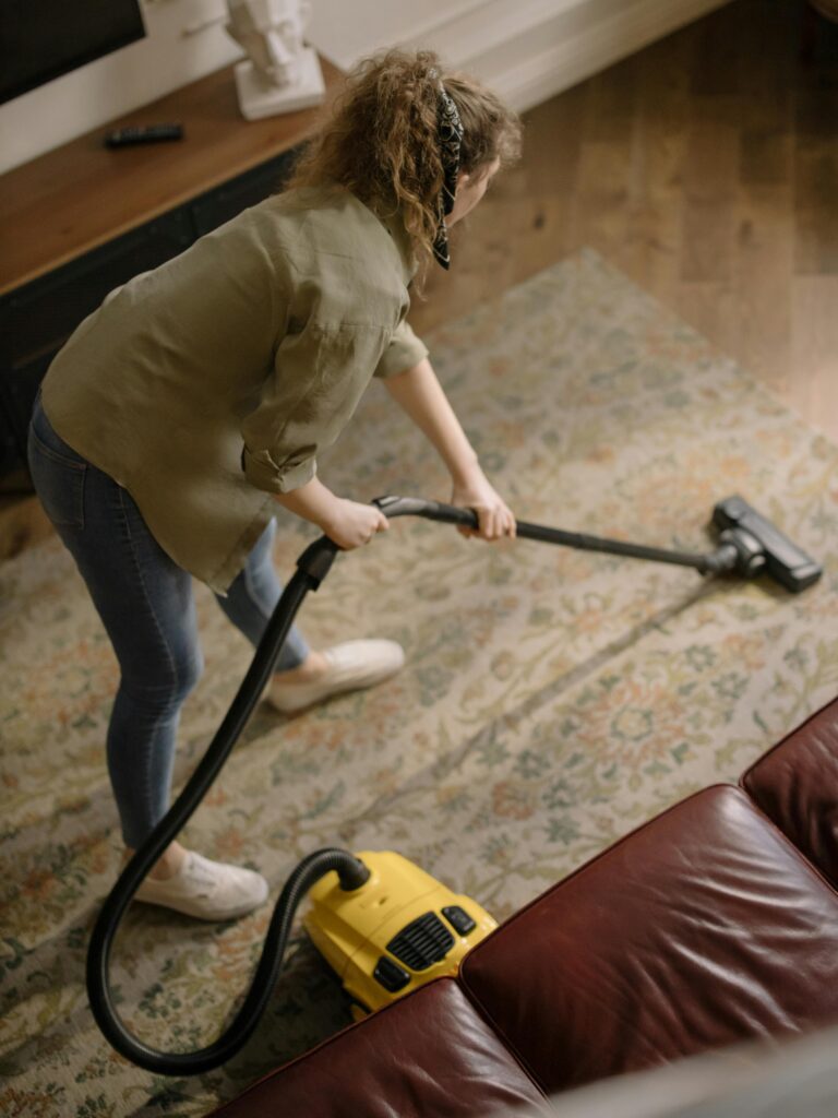 pexels-photo-4107286-4107286 Woman in Long Sleeve Shirt Holding a Vacuum Cleaner
